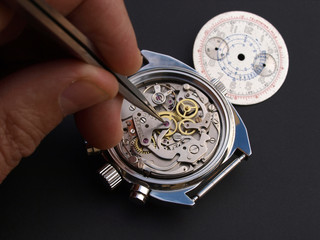 close up of watchmaker adjusting watch
