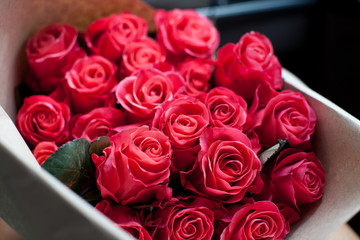 Perfect bouquet of fresh cut roses in car.