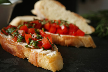 Tasty bruschetta on black background, closeup