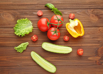 Fresh vegetables on wooden background, top view