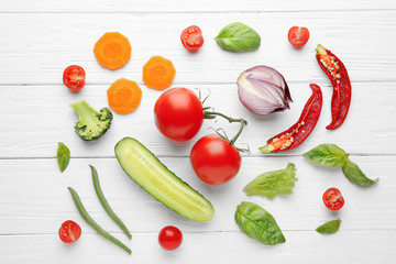 Fresh vegetables on wooden background, top view