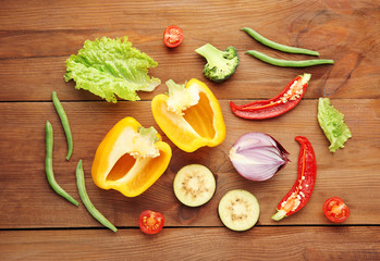 Fresh vegetables on wooden background, top view