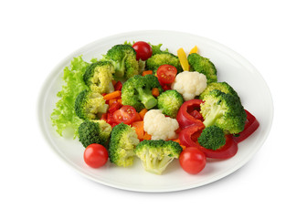Plate with fresh vegetables on light background