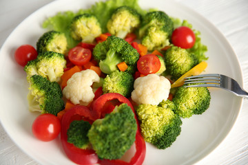 Plate with fresh vegetables, close up