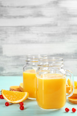 Fresh pumpkin smoothie and fresh oranges on table