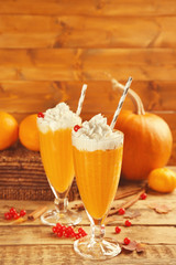 Two glasses of pumpkin smoothies on table