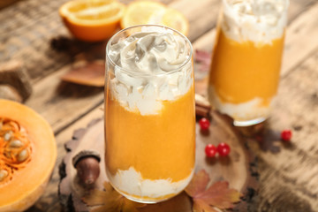 Fresh pumpkin smoothie on wooden background