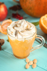 Fresh pumpkin smoothie on wooden background