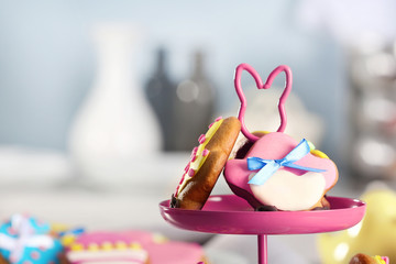 Stand with colourful Easter cookies, closeup
