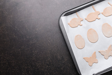 Raw Easter cookies on baking tray, closeup