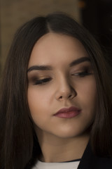 Obraz premium Beautiful brunette woman face with bright makeup. Closeup shot