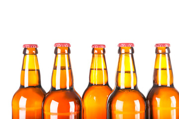 Beer bottles in a row isolated on white