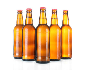 Beer bottles in a row isolated on white
