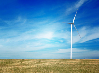 Green technology concept. Wind generator in field