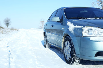 Fototapeta na wymiar Car standing on winter road covered with snow