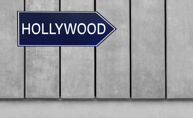 Street sign with word HOLLYWOOD on wooden background
