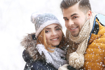 Young couple in snowfall outdoor