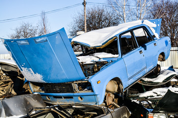 broken car in a landfill