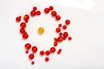 Yellow pea, cherry and plum tomato sorts isolated on white