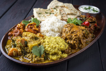 Traditional Indian Curry dishes as close-up on a Thali