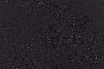 Water drops on dark stone