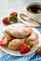 Mini croissants with berries and coffee.