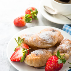Mini croissants with berries and coffee.