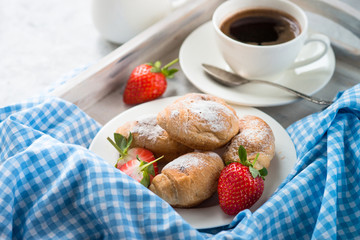 Mini croissants with berries and coffee. 