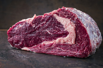 Dry Aged raw Wagyu Rib Eye Steak as close-up on old Sheet