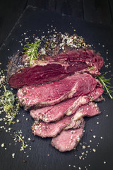 Barbecue dry aged Wagyu Entrecote Steak Bleu as close-up on a slate