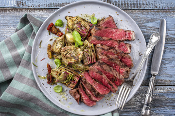 Barbecue Tagliata de Manzo with Artichokes on Plate