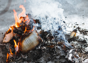 Close-up of a fire in the winter forest of old books, papers, magazines and garbage