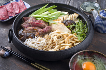 Traditional Japanese Sukiyaki as close-up in Cast Iron Pot