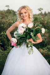 wedding at sunset with a beautiful bride and a large bouquet of peonies, peony wedding