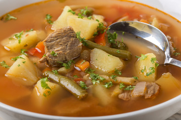Bowl of vegetable beef soup with spoon