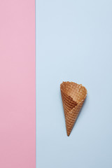 the Empty Ice Cream Cone on blue and pink background