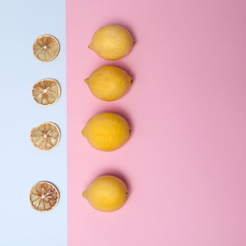 Fresh lemon and dried orange slices on a blue and pink background. greeting card