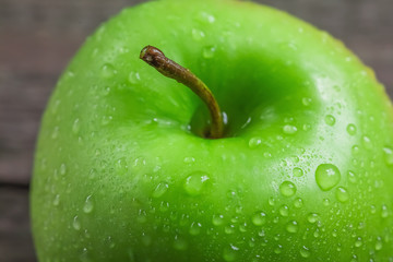 Ripe green apples on wooden background