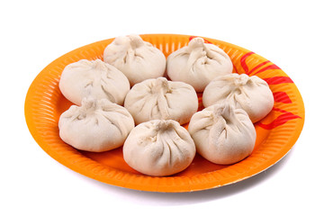 Frozen manti laying on the orange plate