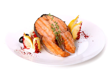 Fried salmon fish with a lemon and olives