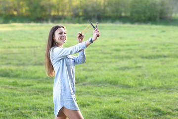 Woman using a slingshot.
