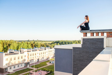Young woman doing yoga on the roof