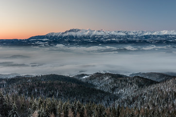 Fototapeta na wymiar Beautiful winter panorama over Spisz highland to snowy Tatra mountains in the morning, Poland