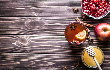 Tea with lemon and honey on wooden background