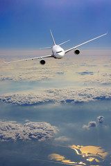 Fototapeta na wymiar Airplane fly over clouds. Transportation travel concept