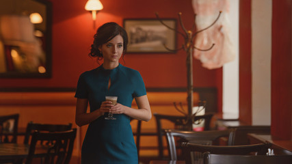 Pensive pretty girl in classic elegant dress standing at the cafe going to drink coffee.