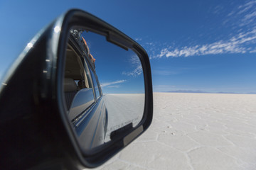 Car mirror with view of the awesome salt flats of Uyuni with cle