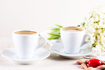 espresso, nuts and bouquet of flowers