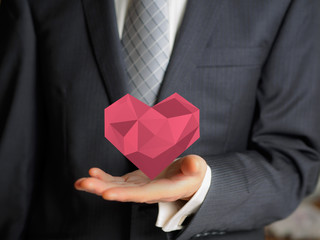 business man hold low poly heart shape