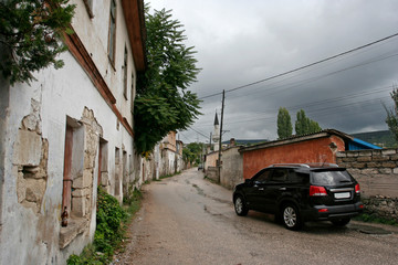 The car on the unfrequented street of the Old Town of Bakhchisarai, Crimea